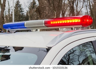 Red And Blue Lights Of Police Car In Day Time. Patrolling The City, Crime Scene.Selective Focus.