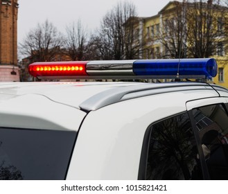 Red And Blue Lights Of Police Car In Day Time. Patrolling The City, Crime Scene.Selective Focus.