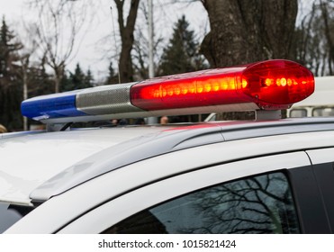 Red And Blue Lights Of Police Car In Day Time. Patrolling The City, Crime Scene.Selective Focus.