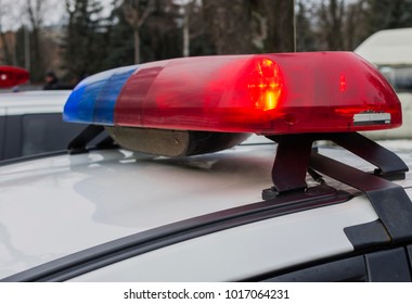 Red And Blue Lights Of Police Car In Day Time. Patrolling The City, Crime Scene.Selective Focus.