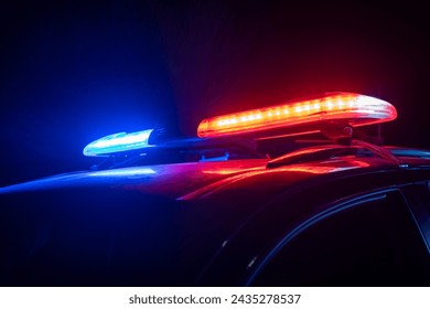 Red and blue lights of a police car at night, stock photo