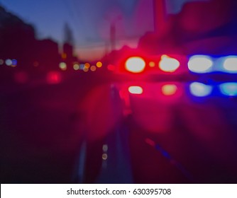 Red and blue Lights of police car in night time. Night patrolling the city. Abstract blurry image. - Shutterstock ID 630395708
