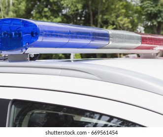 Red And Blue Lights Of Police Car In Day Time. Selective Focus.