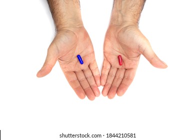 Red and blue pills on hand isolated on white background. They represent the choice between embracing the truth and reality, red or blissful ignorance, blue
