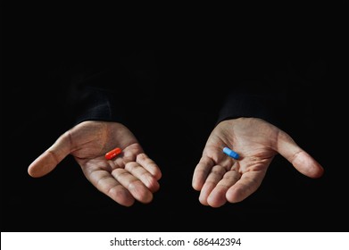 Red and blue pills on hand isolated on black background - Powered by Shutterstock
