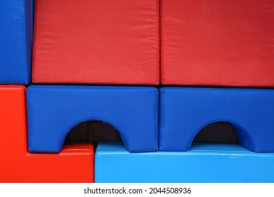 Red And Blue Soft Tumbling Mat Stands In Kindergarten Gym Indoor Front View. PC And PE Concept.