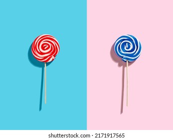 Red, Blue And White Colored Swirl Round Candy Lollipops On Pink And Blue Duotone Background.