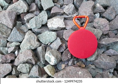 Red Bluetooth Speaker On Stone Background