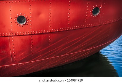 Red Boat Detail With Water Reflection.