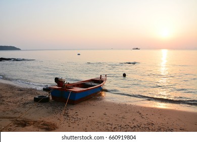 Red Boat On The Beach In Sun Rise