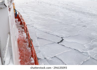 Red Boat Sailing Through Pieces Of Cracked Sea Ice