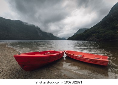 Red boats ashore a Fjord   - Shutterstock ID 1909582891