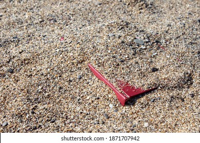 Red Book On The Sand On A Blurry Background, Covered With Sand