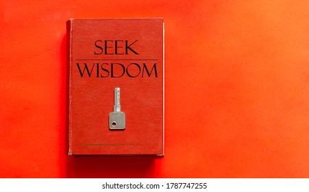 red book with text Seek Wisdom and a key on a red background