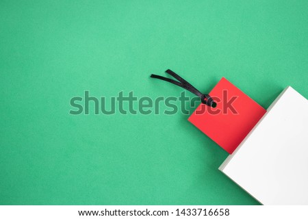 Red bookmark and a white book on a green background