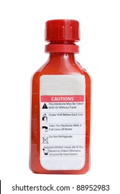 Red Bottle Of Medicine With Warning Label Isolated On A White Background