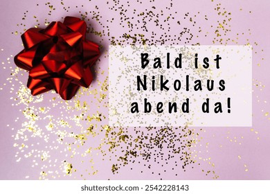 Red bow with gold glitter on a pink background. The words Bald ist Nikolaus abend da are written below the bow - Powered by Shutterstock