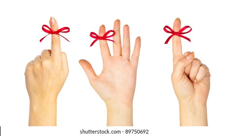 Red bow on finger isolated on white background