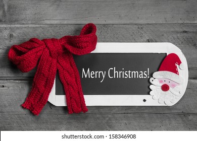 Red Bow On Menu Board With Merry Christmas Message On Wooden Background