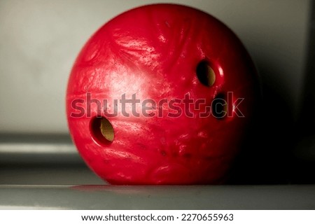 red bowling ball in stand. red Colored bowling ball at bowling alley,relaxing and sport concept.