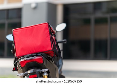 A red box is placed on the motorbike to deliver the product to the customer. - Shutterstock ID 1820639150