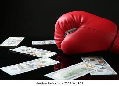 Red boxing glove and dollar banknotes on black mirror surface - Powered by Shutterstock