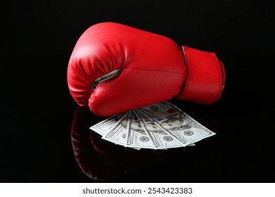 Red boxing glove and dollar banknotes on black mirror surface - Powered by Shutterstock