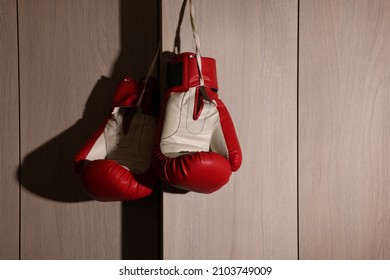 Red boxing gloves hanging on locker door in changing room