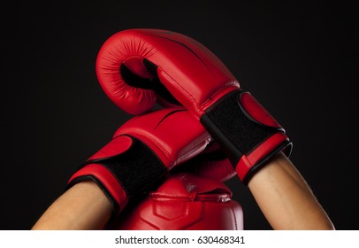 Red Boxing Head Guard With A Pair Of Red Boxing Gloves