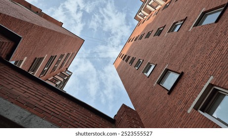 red brick apartment building with windows and cloudy sky - Powered by Shutterstock