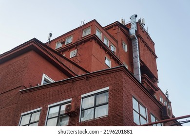 Red Brick Building With Square Windows And Metal Duct