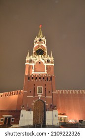 Red Brick Clock Tower Against A Dark Sky.