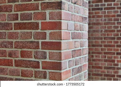Red brick and brick edge from pillar in front of wall as texture background
