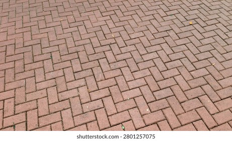 Red brick pavement with herringbone pattern in urban setting