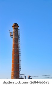 Red brick Victorian chimney stack rising above a heritage building, showcasing classic period architecture and historic character.