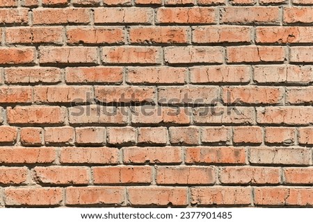 A red brick wall abstract background or texture, new and clean. for pattern background. wide panorama picture. on a bright sunny day with shadows.