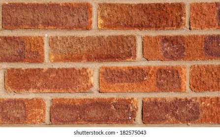 Red brick wall with brown-grey pointing, landscape, medium close.