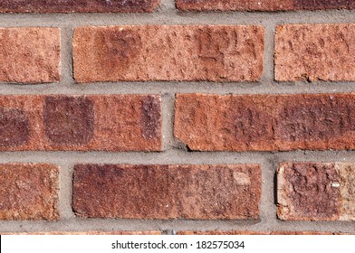 Red brick wall with grey pointing, landscape, close.
