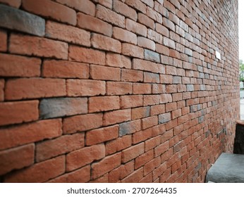Red brick wall in perspective.