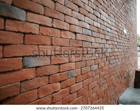Red brick wall in perspective.