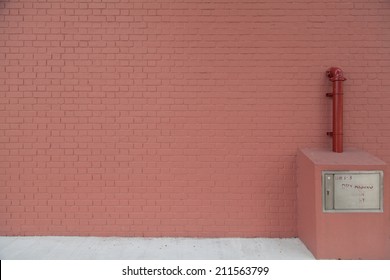 Red brick wall with red pipe