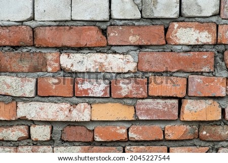 Red brick wall, real wall of an old brick house, close-up.