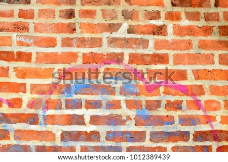 Red Brick Wall with Spray Paint