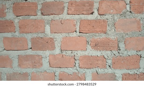 Red Brick Wall Texture Background - Raw Clay Bricks with Cement Mortar Close Up