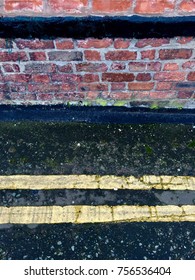 Red Brick Wall And Two Yellow Lines