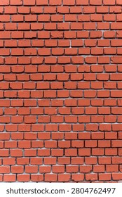 Red brick wall with uniform shape and clear mortar joints, showing even construction detail