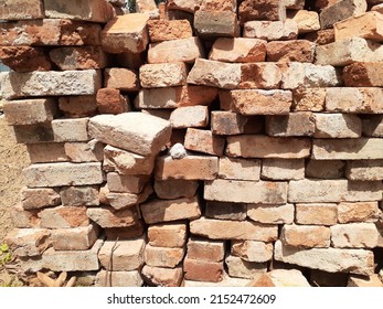 Red Bricks Pile With Sunlight Background.