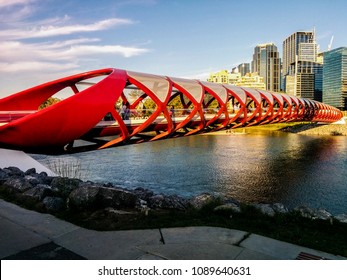 Red bridge called Peace Bridge over Bow river in Calgary, Alberta, Canada,
