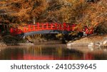 A red bridge over a pond leads to a japanese garden at Duke University in Durham, North Carolina. Duke garden is one of the attractions in the city and is open to the public for free.