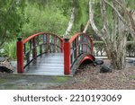 Red bridge and trees at the Bundaberg Botanic Gardens in Queensland, Australia